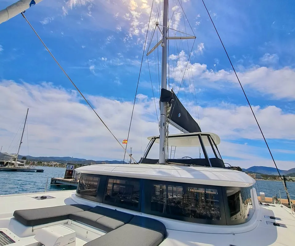 Exterior view of silver elli, a Lagoon 46 catamaran at Sant Antoni de Portmany, Spain