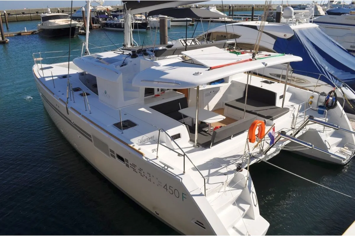 Exterior view of QUICOM, a Lagoon 450 Fly catamaran at Sant Antoni de Portmany, Spain