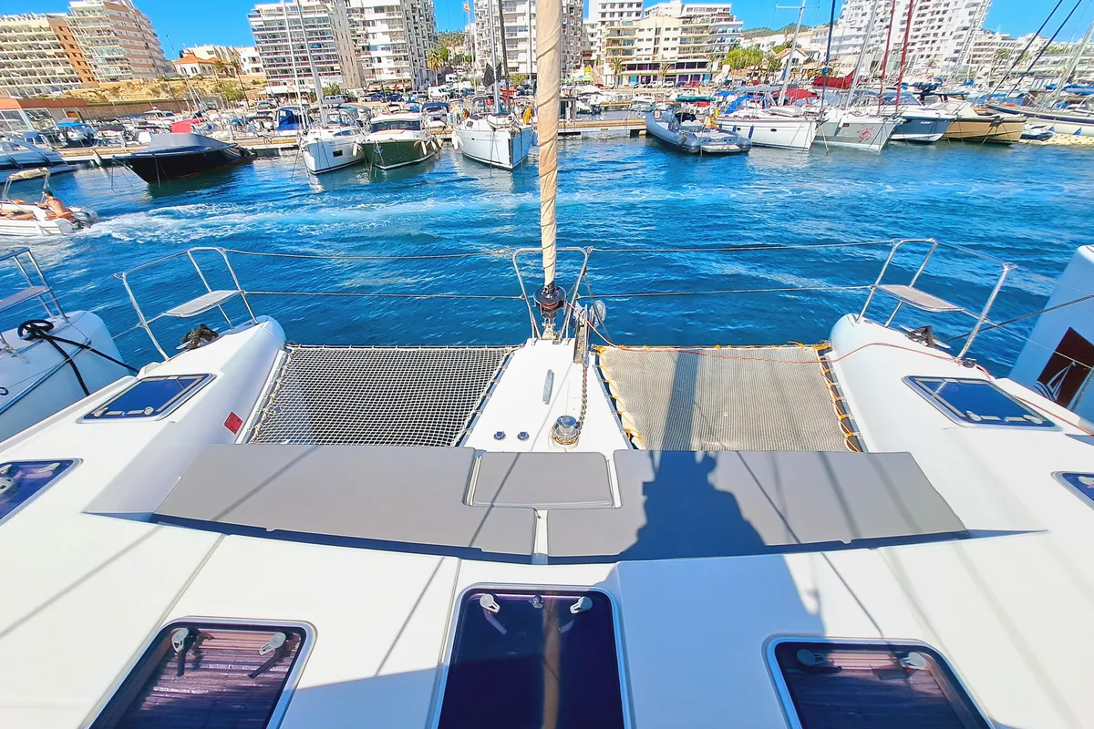 Exterior view of THE MOB, a Lagoon 421 catamaran at Sant Antoni de Portmany, Spain