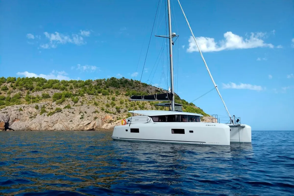 Exterior view of Genista II, a Lagoon 42 catamaran at Sant Antoni de Portmany, Spain