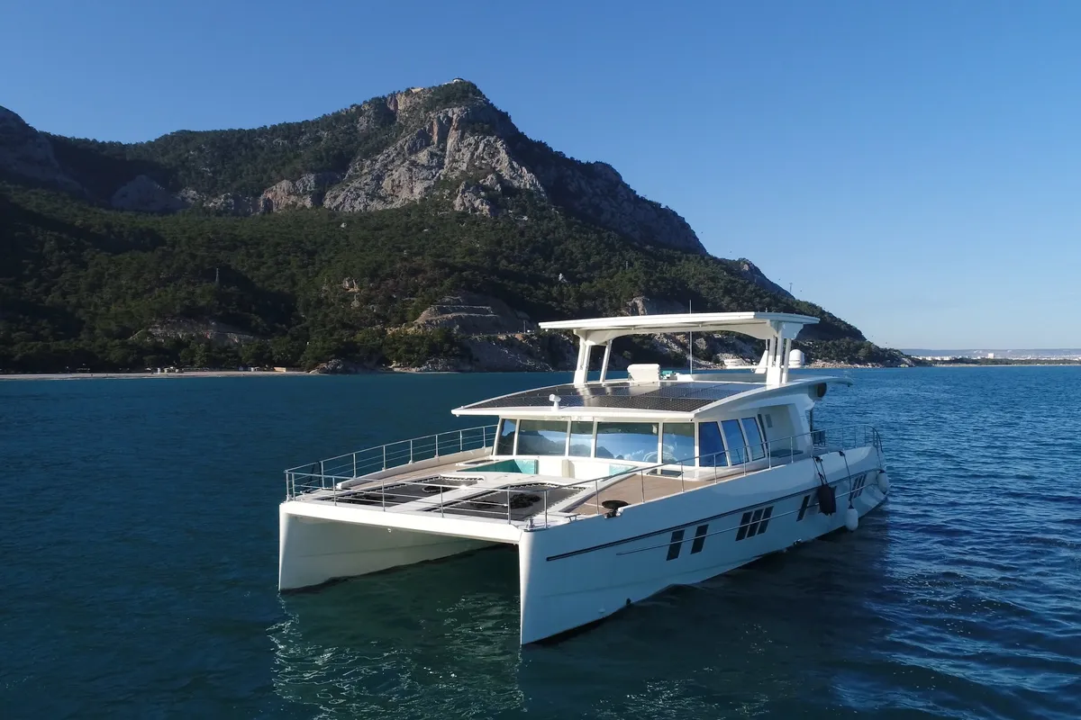 Exterior view of Premium +, a Gulet Serenity 64 catamaran at Sant Antoni de Portmany, Spain