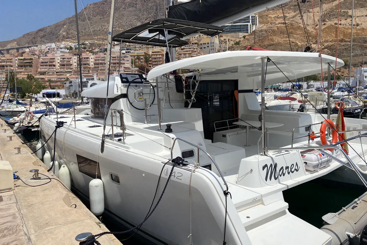 Exterior view of Mares, a Lagoon 42 catamaran at Sant Antoni de Portmany, Spain