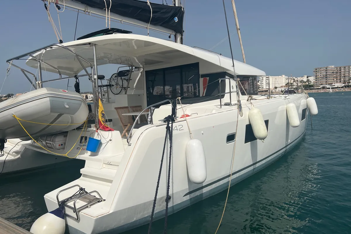Exterior view of Mares, a Lagoon 42 catamaran at Sant Antoni de Portmany, Spain