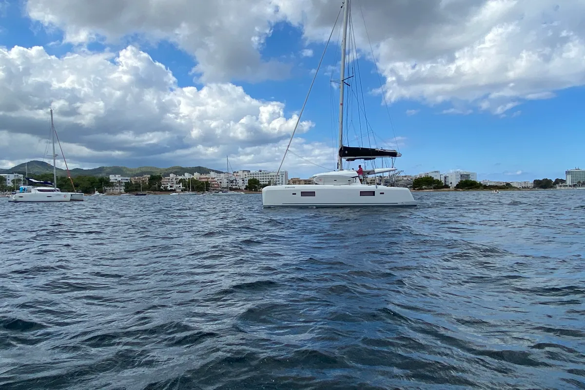 Exterior view of Mares, a Lagoon 42 catamaran at Sant Antoni de Portmany, Spain