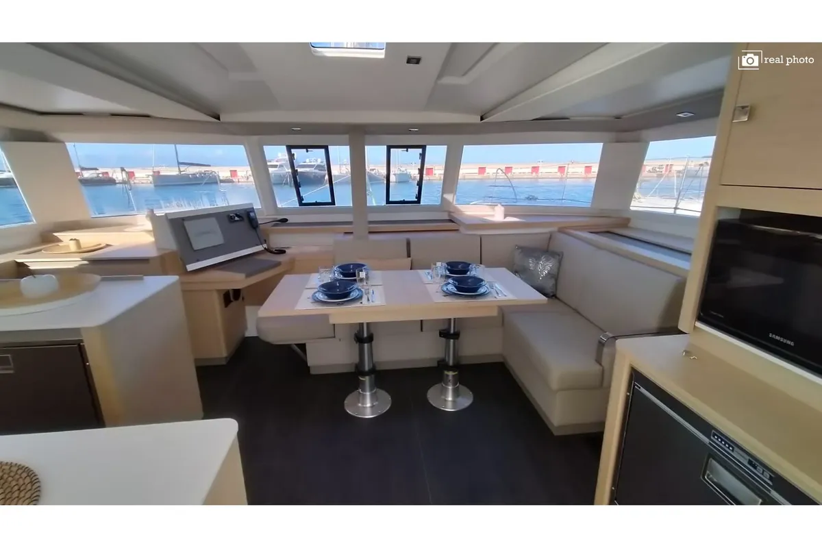 Salon of Agitation - A/C, Generator, Water maker. Solar panel, a Fountaine Pajot Astréa 42 catamaran at Cannigione, Italy