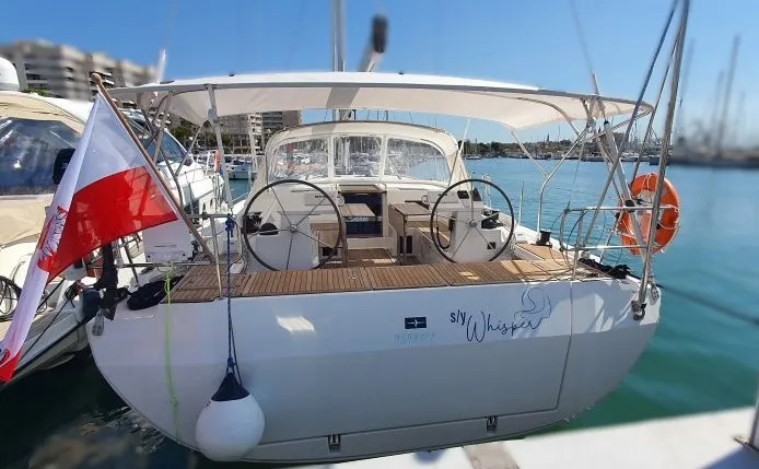 Exterior view of Whisper, a Bavaria C45 sailboat at Cala Egos, Spain
