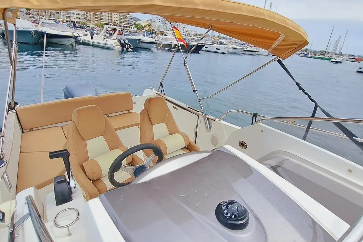 Cockpit of CORRECAMINOS BEEP BEEP, a Jeanneau Cap Camarat 755WA motorboat at Sant Antoni de Portmany, Spain