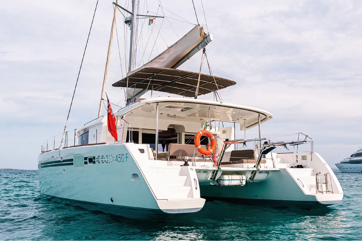 Exterior view of Lluna, a Lagoon 450 F catamaran at Sant Antoni de Portmany, Spain