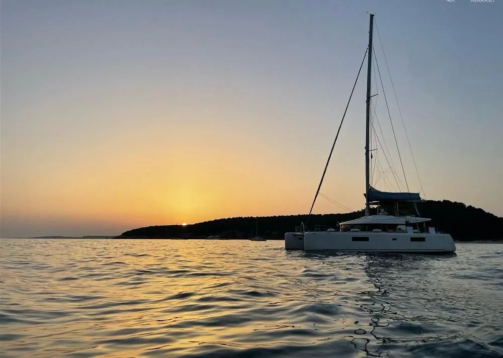 Exterior view of Jolie, a Lagoon 52F catamaran at Sant Antoni de Portmany, Spain